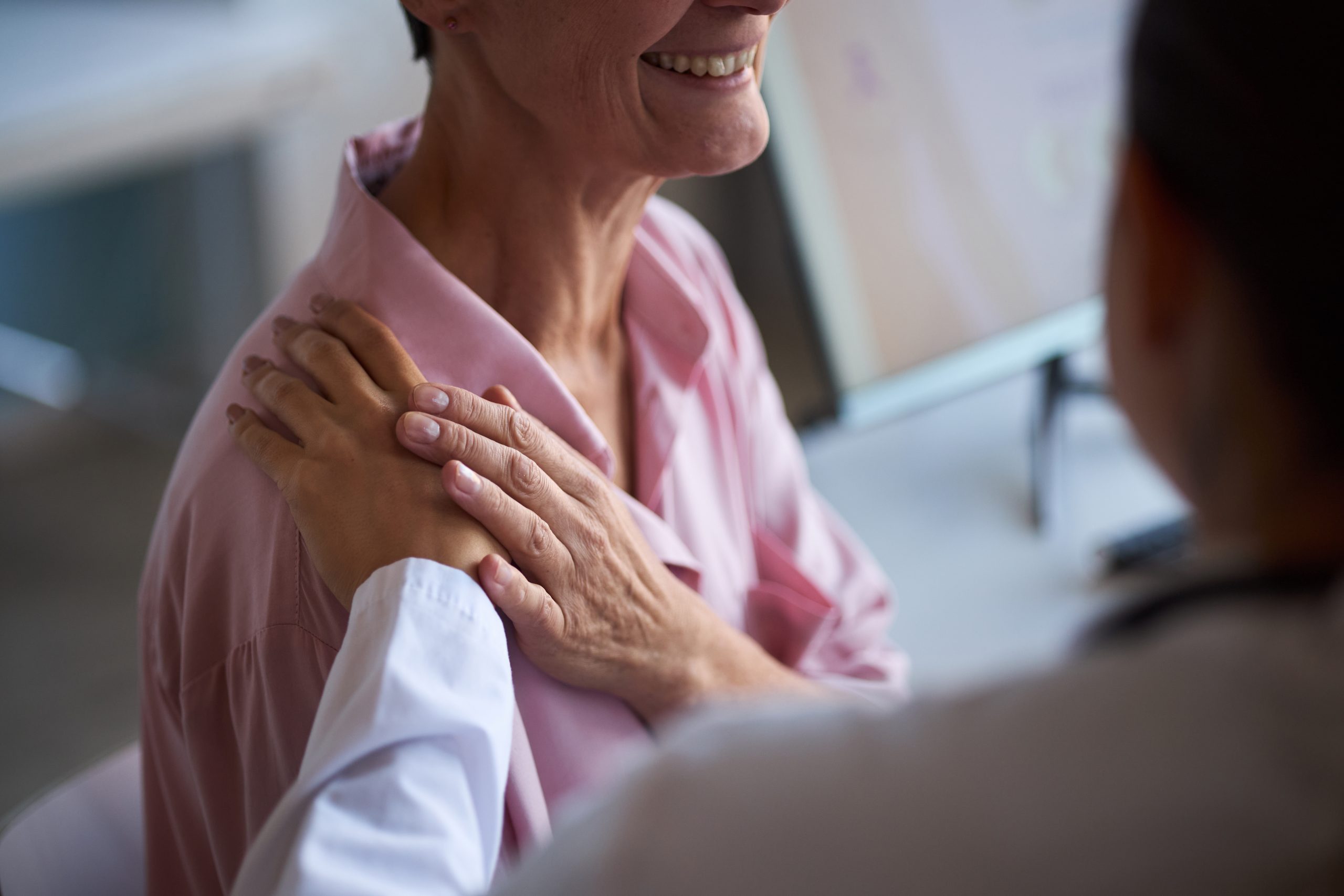 Middle Aged Woman Receiving Support from Doctor during Cancer Consultation