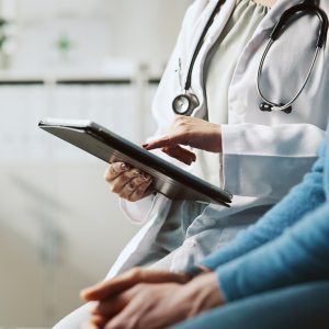 Hands, doctor and patient with tablet, explain and conversation with feedback for diagnosis. People, closeup and medical with professional, man and tech for online results, review illness and report