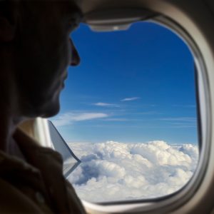 commercial plane passenger sitting and looking out the window